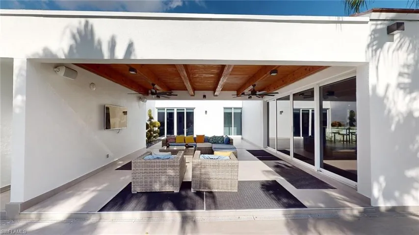Back of house with an outdoor hangout area and ceiling fan