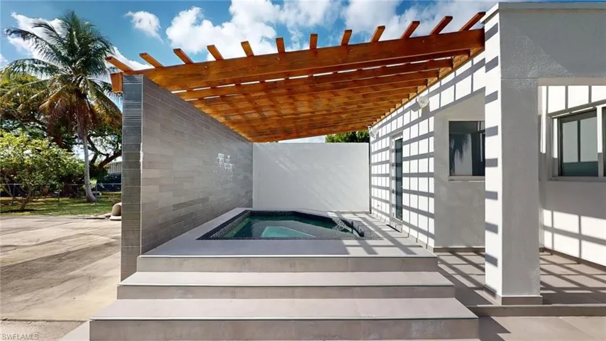 View of pool featuring a pergola, a patio area, and an in ground hot tub