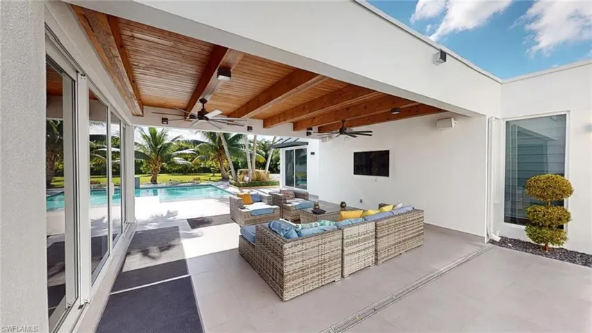 View of patio featuring an outdoor living space and ceiling fan