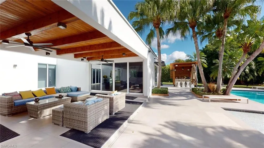 View of patio / terrace with an outdoor living space, ceiling fan, and exterior bar