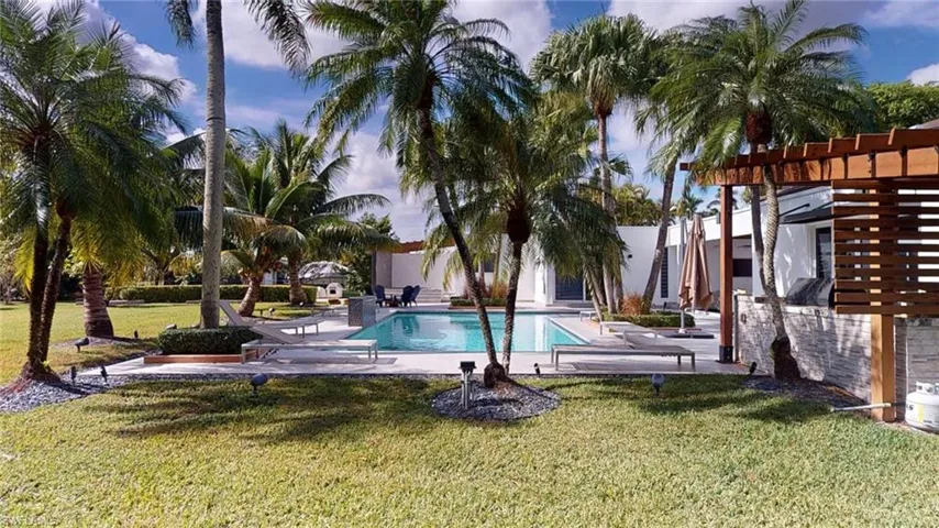 View of swimming pool with a yard, a pergola, and a patio