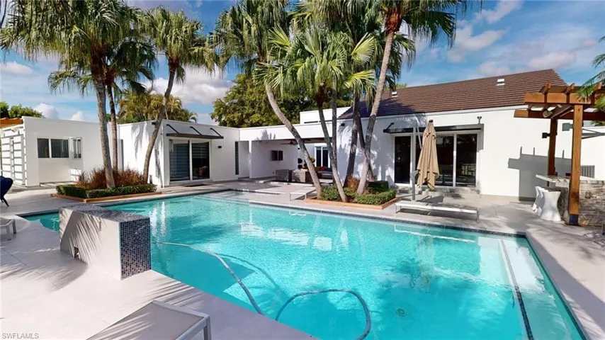 View of swimming pool featuring a patio and a pergola