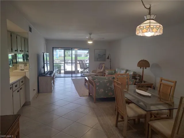 Tiled dining area featuring sink and ceiling fan