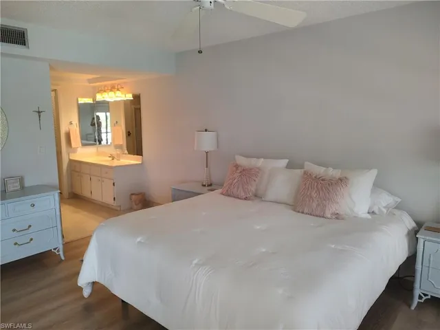 En suite bedroom has a slider leading out to the lanai