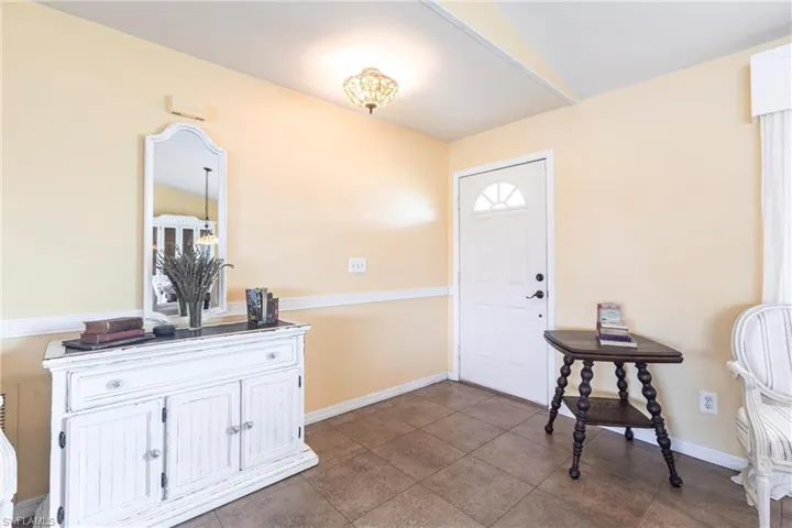 Tiled foyer with baseboards