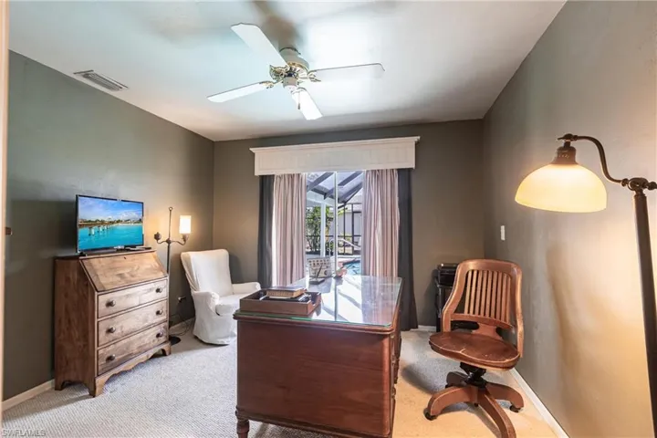 Office area with ceiling fan, light colored carpet, baseboards, and visible vents