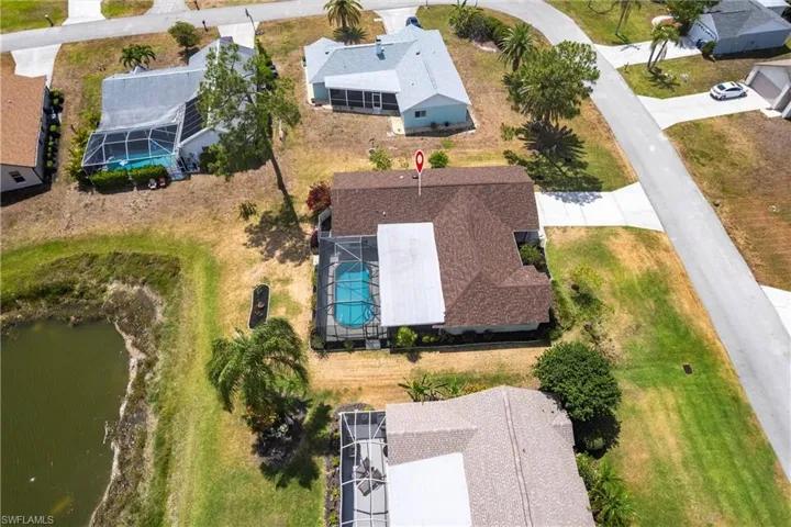 Birds eye view of property with a water view