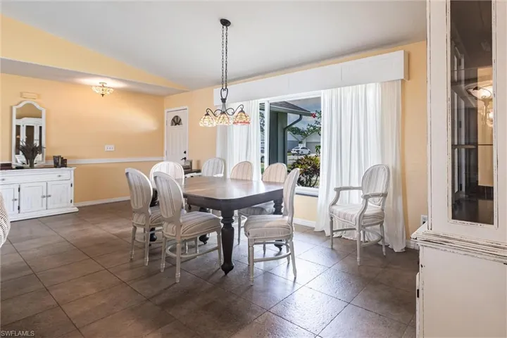 Dining area with baseboards and lofted ceiling