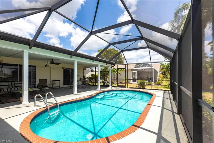Outdoor pool with a patio and ceiling fan