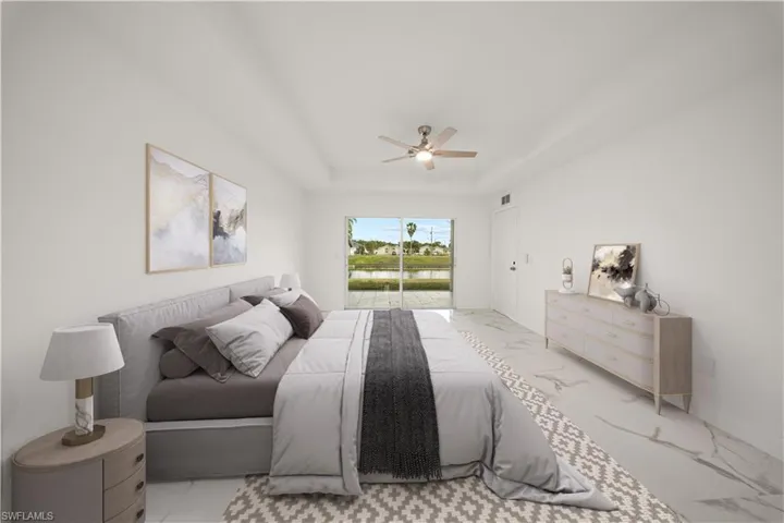 Bedroom with access to exterior, a ceiling fan, and a raised ceiling
