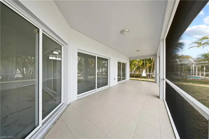Unfurnished sunroom featuring tile patterned floors