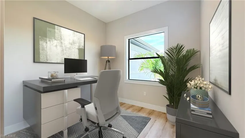Den/Office featuring baseboards and light wood finished floors. Staged picture