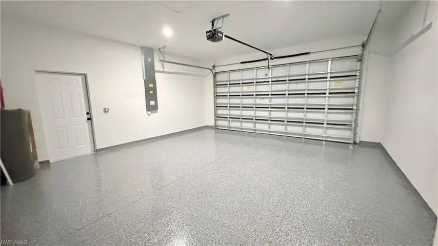 Garage with electric panel and a garage door opener