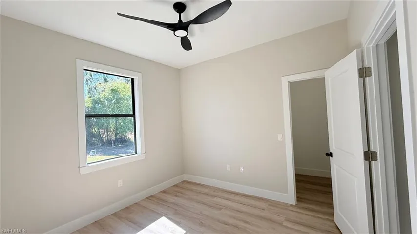 Spare room with light wood-type flooring and ceiling fan