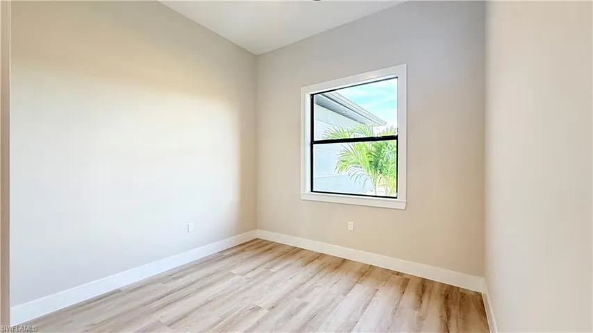 Den/Office featuring light wood-style floors and baseboards