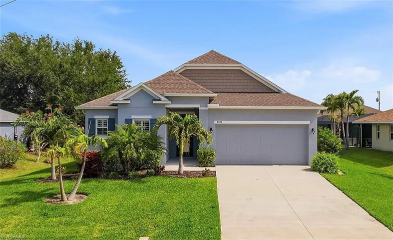Contemporary single-story residence featuring a two-car garage, concrete driveway, and a low-sloped shingle roof