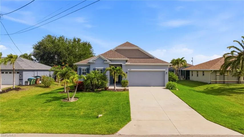 Single-story residence featuring a two-car garage, a concrete driveway, and a shingled roof