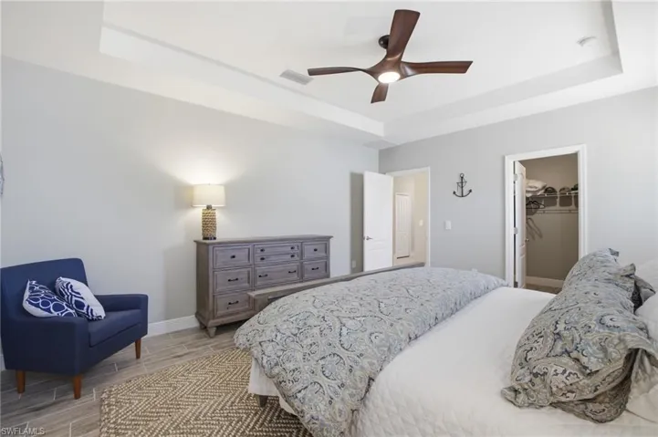 Recessed ceiling with a modern ceiling fan and recessed lighting