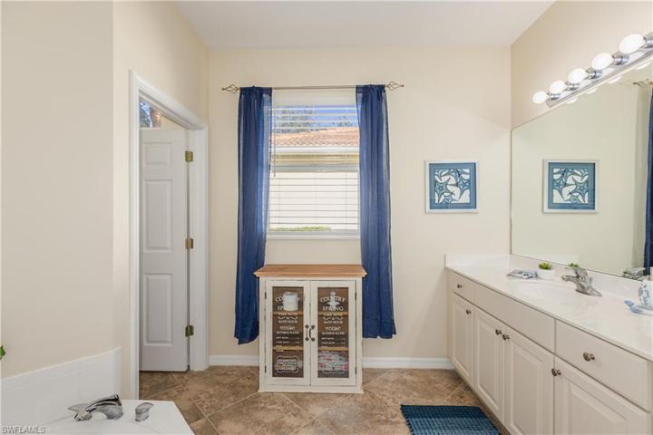 Primary bath has 2 large vanities, window and watercloset