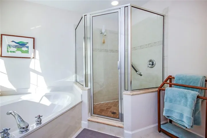Bathroom with tile patterned flooring and separate shower and tub