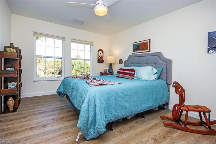 Bedroom with hardwood / wood-style floors and ceiling fan