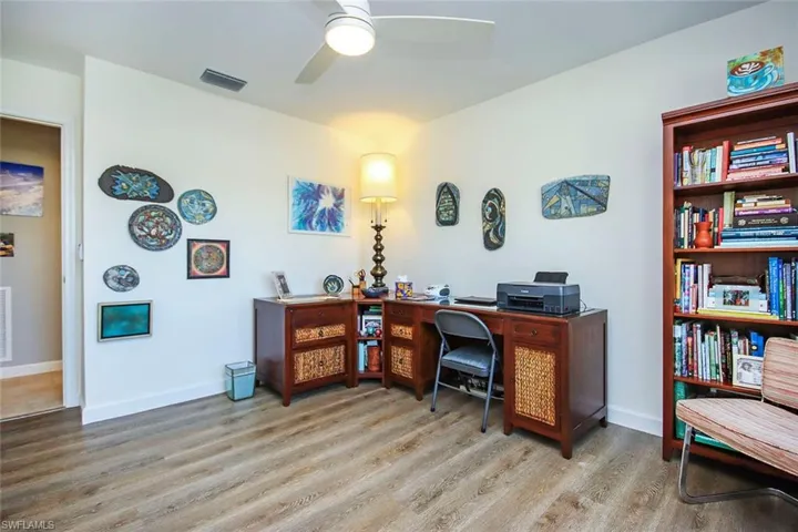 Third bedroom/artist studio featuring light wood-type flooring and ceiling fan
