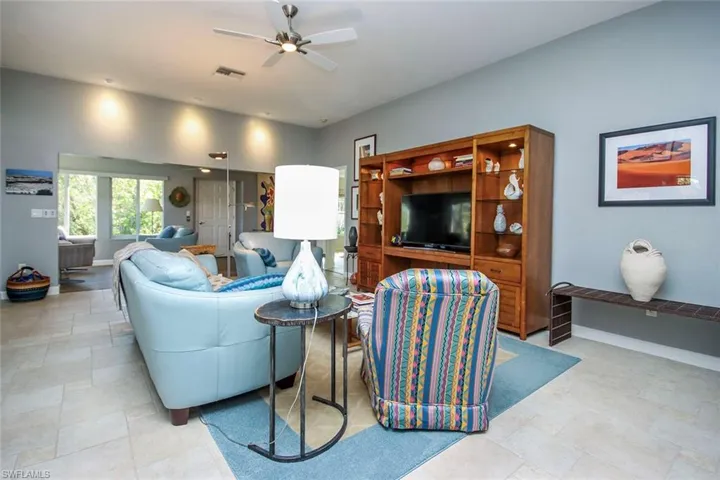 Tiled living room featuring ceiling fan