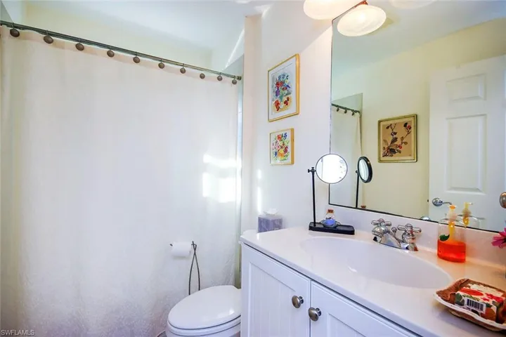 Bathroom with walk in shower, vanity, and toilet