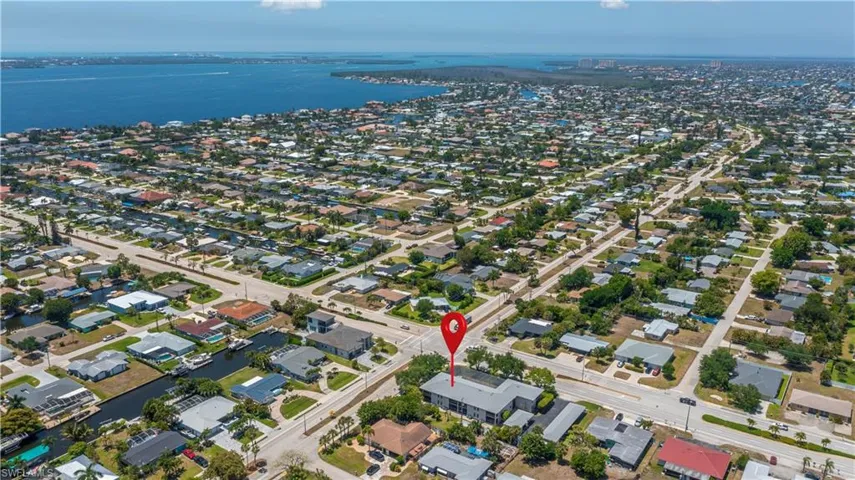 Aerial perspective showcasing the surrounding residential district and nearby water features