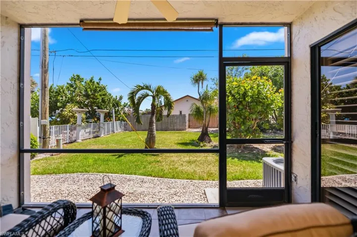 Screened lanai with ceiling fan and direct access to the backyard