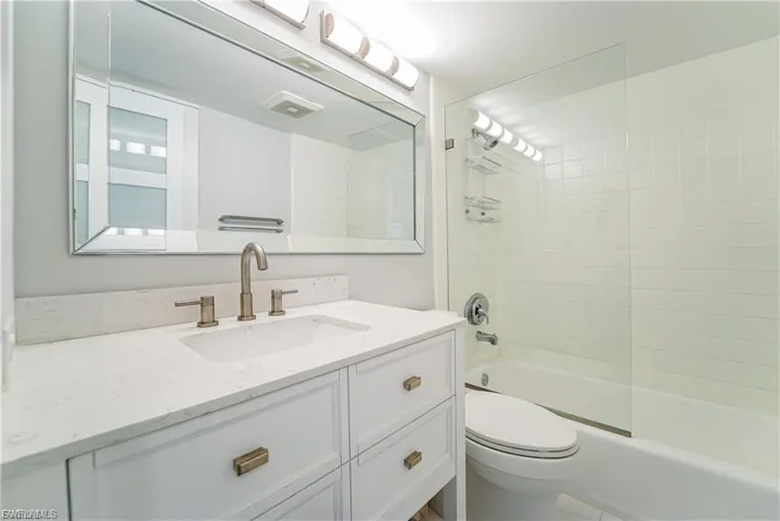 Bathroom with vanity and  shower combination