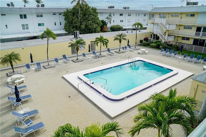 Community pool featuring a patio