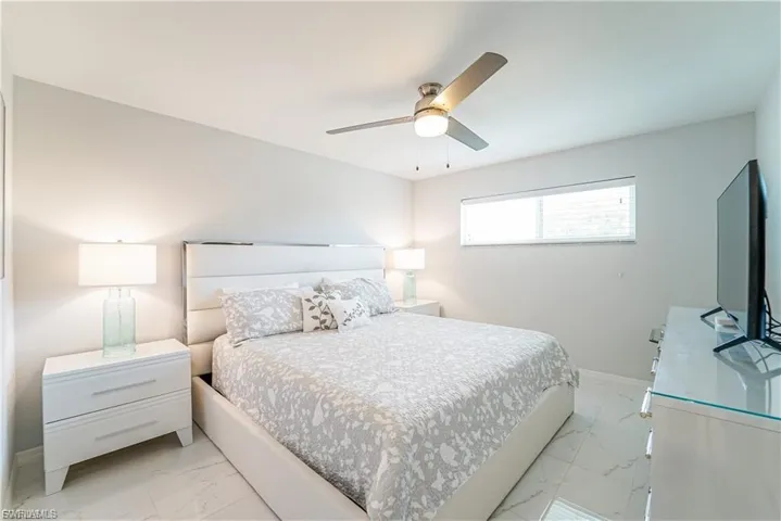 Bedroom with light marble finish flooring and ceiling fan