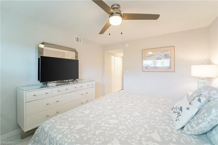 Bedroom with ceiling fan and baseboards