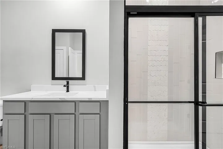 Bathroom with a stall shower and vanity