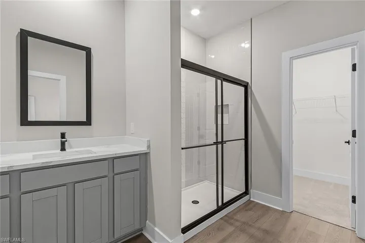 Kitchen featuring gray cabinets, appliances with stainless steel finishes, wood finish floors, and recessed lighting