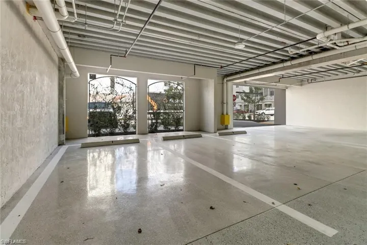 Covered garage space with storage closet.