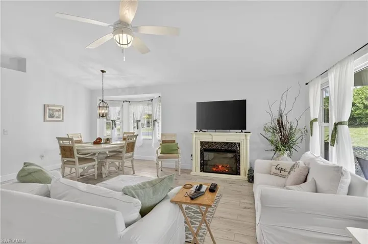 Open-concept living area with light-toned wood-finish flooring