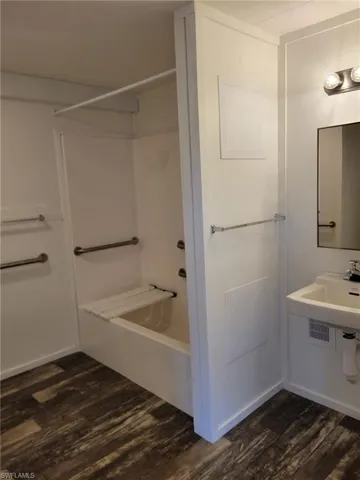 Bathroom featuring shower / bathtub combination and wood finished floors