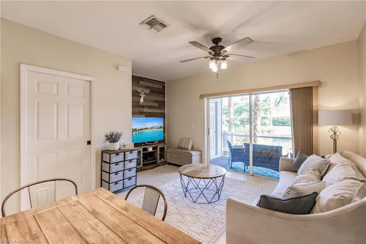 Tiled living room featuring ceiling fan