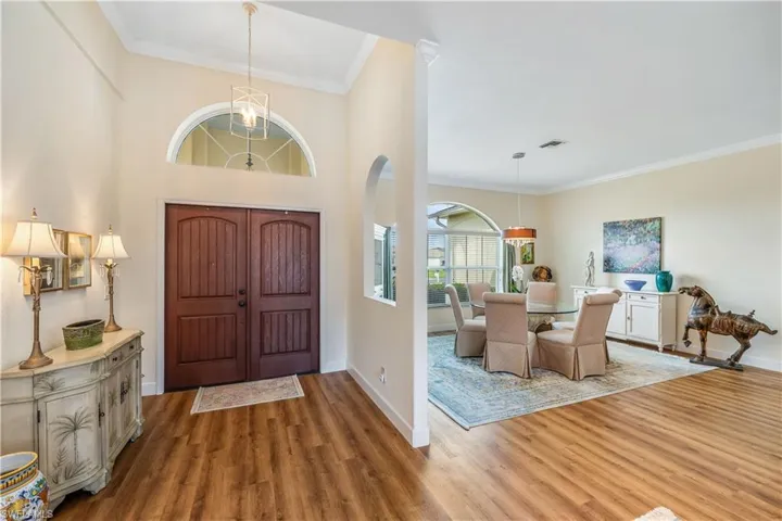 Foyer featuring ornamental molding and hardwood / wood-style floors