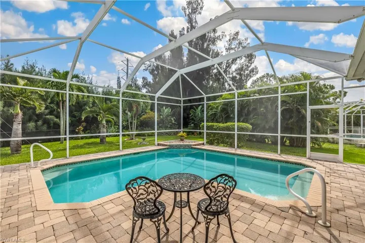 View of pool with a patio area and a lanai