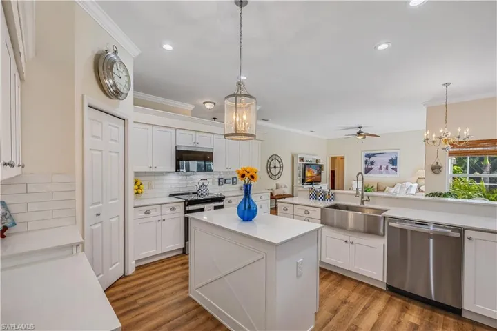 Kitchen featuring sink, appliances with stainless steel finishes, backsplash, and light hardwood / wood-style floors