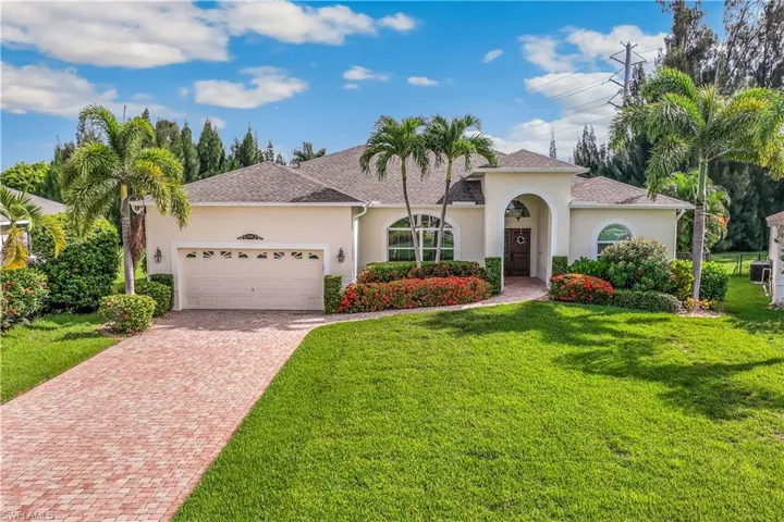 Mediterranean / spanish-style home with a garage and a front yard