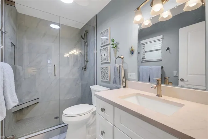 Ensuite primary bathroom features a stunning walk-in shower.