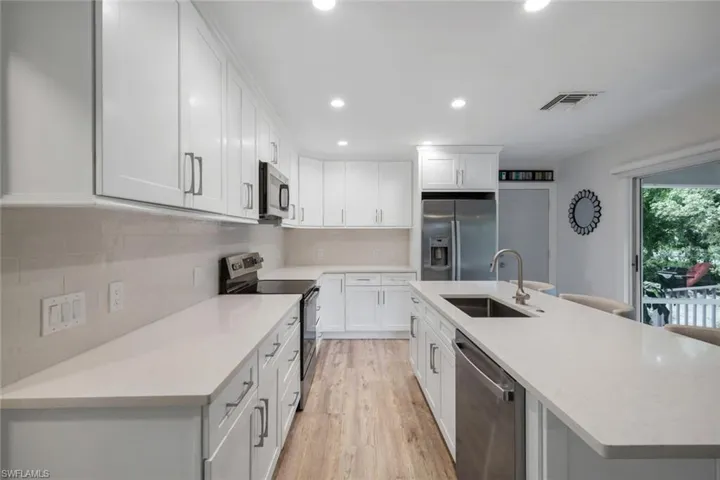 Kitchen features shaker cabinets, quarts countertops and stainless appliances.