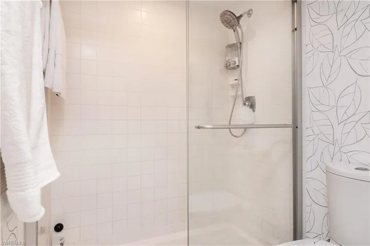 Bathroom featuring toilet and an enclosed shower