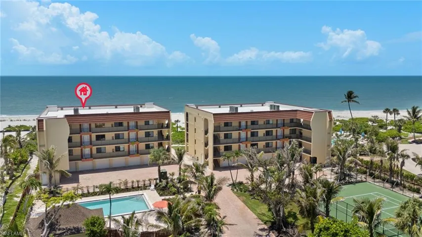 Drone / aerial view of unending shoreline and a pool area