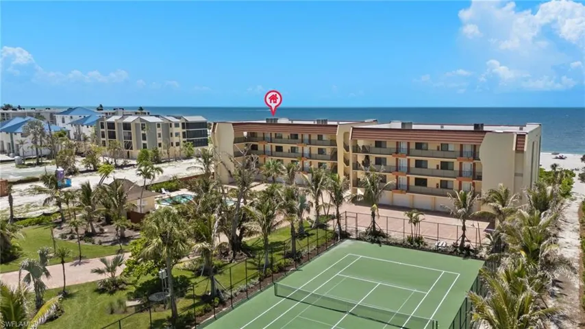 Drone / aerial view of apartment complex / building and a large body of water