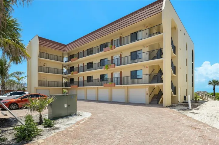 View of apartment building / complex with decorative driveway